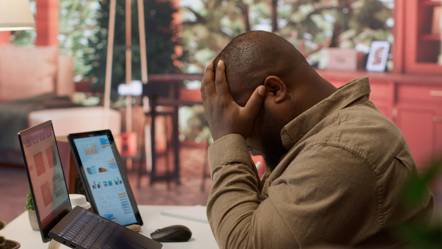 A business owner reviewing a digital dashboard on a laptop